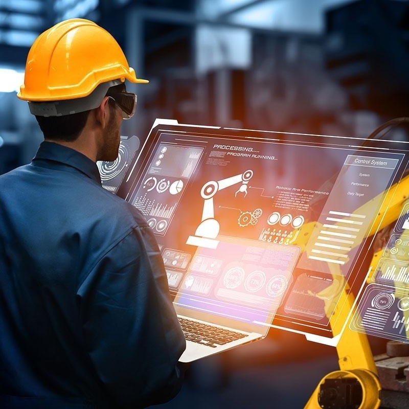 An engineer monitors robot arms through real-time production dashboards in a smart manufacturing plant, illustrating where digital pays back fastest in the manufacturing industry.